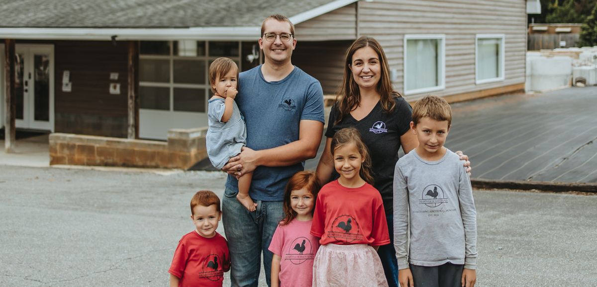 Family of six standing together in front of a house